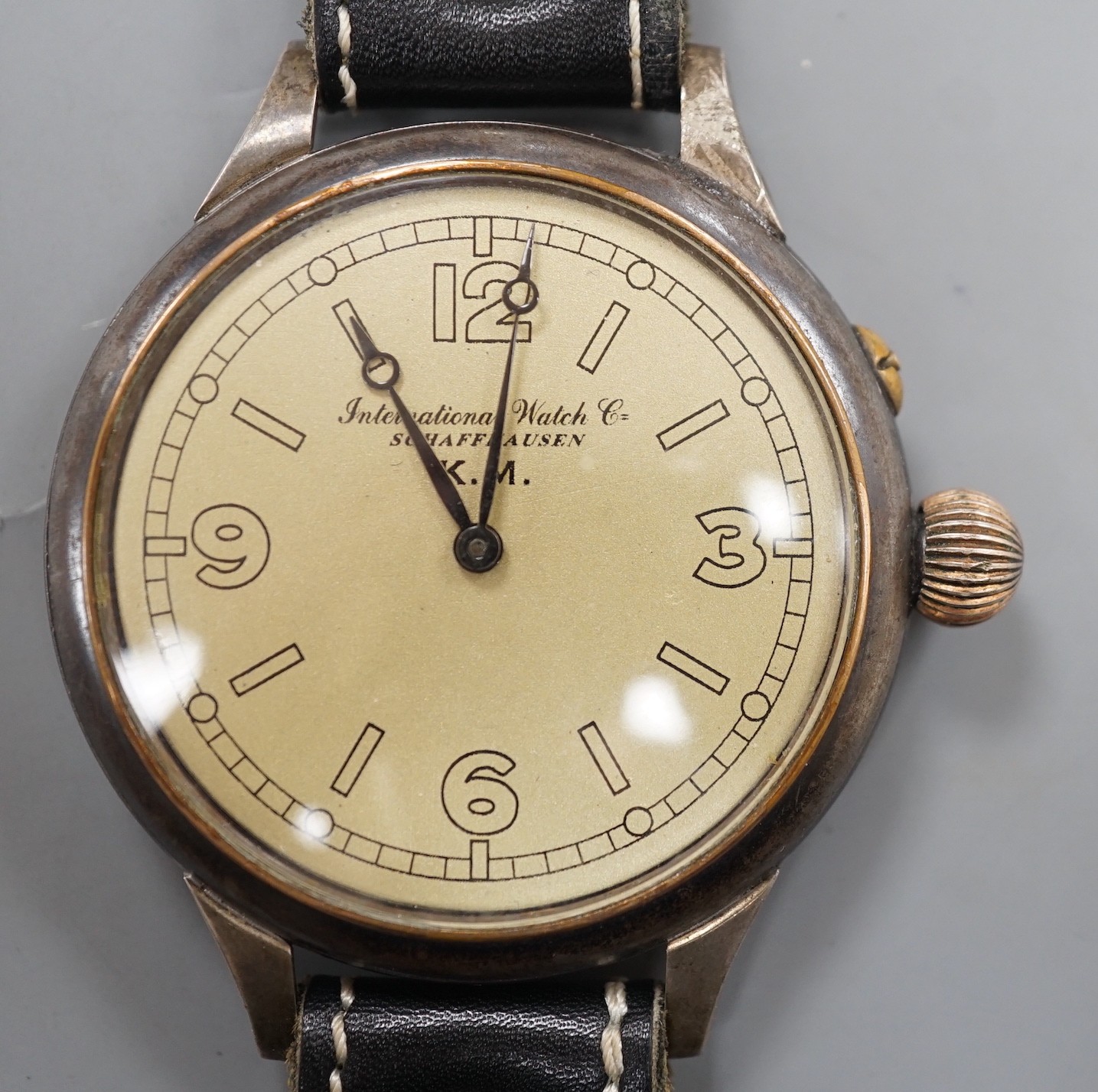 A Kriegsmarine style gun metal manual wind wrist watch, converted from a pocket watch, with later adapted dial, on a leather strap